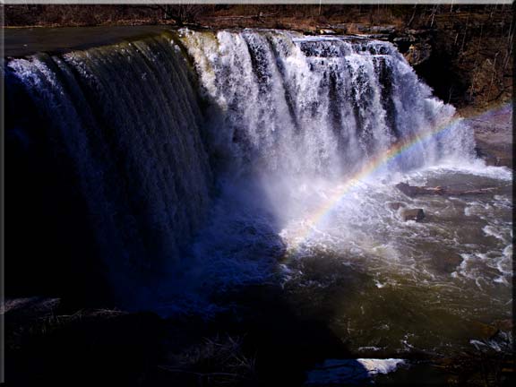 One of several waterfall photographs of a rainbow at Ludlowville Falls.