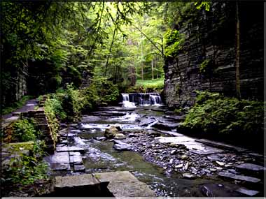 Photograph of a distant, glowing waterfall.