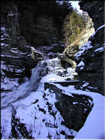 A coating of sunlit snow emphasizes the lovely angles and steep cliffs in Robert Treman State Park.