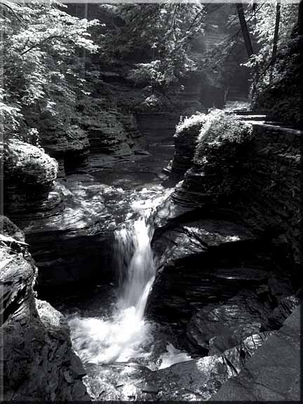 Black and white photography emphasizes the structure of the rock walls.