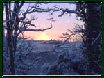 Photograph of the sunrise through a vanishing snowstorm.