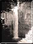 A sepia photograph of Taughannock Falls in sunlight.